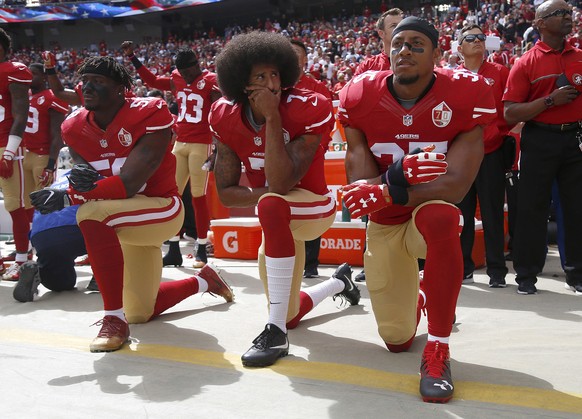 October 2, 2016, Santa Clara, CA, USA: From left, The San Francisco 49 s Eli Harold 58, Colin Kaepernick 7 and Eric Reid 35 kneel during the national anthem before their a game against the Dallas Cowb ...