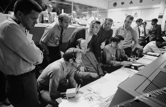 (14 April 1970) ---In this April 14, 1970 photo made available by NASA, a group of six astronauts and two flight controllers monitor the console activity in the Mission Operations Control Room (MOCR)  ...