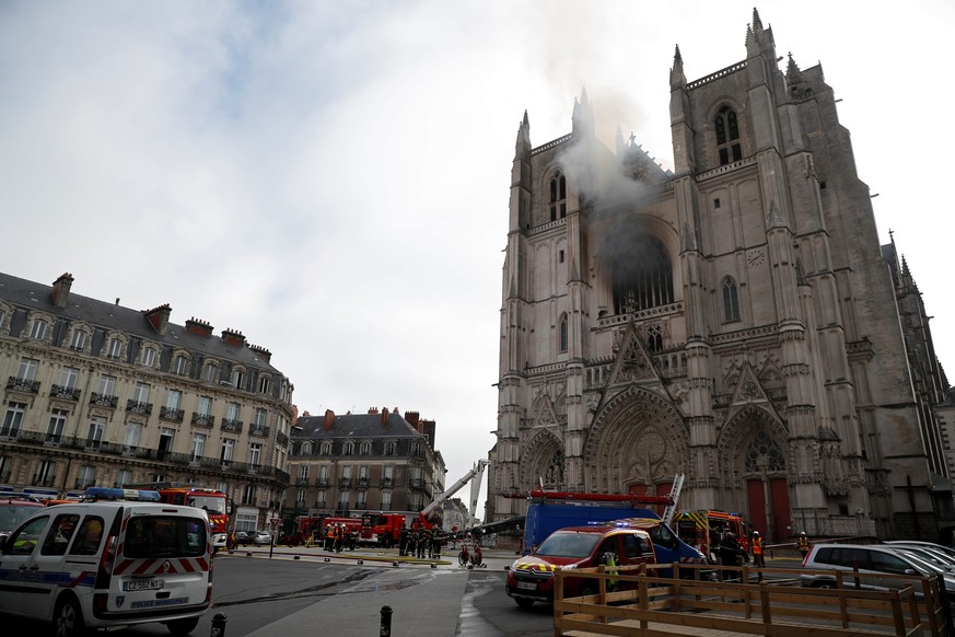 French firefighters gather at the scene of a blaze at the Cathedral of Saint Pierre and Saint Paul in Nantes, France, July 18, 2020. REUTERS/Stephane Mahe
