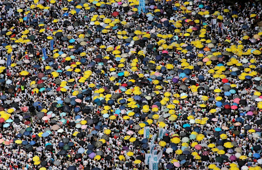Demonstrators hold yellow umbrellas, the symbol of the Occupy Central movement, during a protest to demand authorities scrap a proposed extradition bill with China, in Hong Kong, China June 9, 2019. R ...