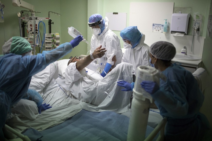 A medical crew receive a COVID-19 patient into the intensive care unit at the Joseph Imbert Hospital Center in Arles, southern France, Wednesday, Oct. 28, 2020. Many French doctors are urging a new na ...