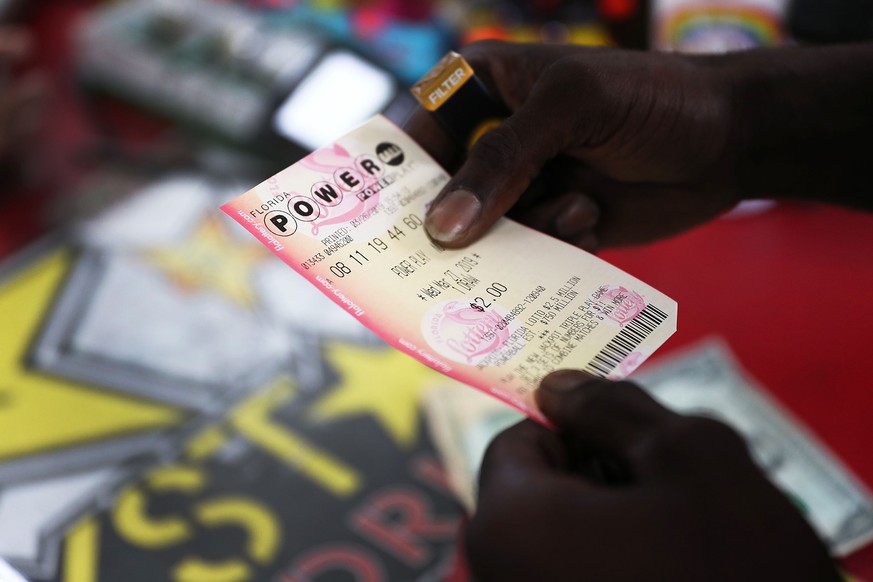 BOYNTON BEACH, FLORIDA - MARCH 26: George Hollins buys a Powerball ticket at the Shell Gateway store on March 26, 2019 in Boynton Beach, Florida. Wednesday&#039;s Powerball drawing will be an approxim ...