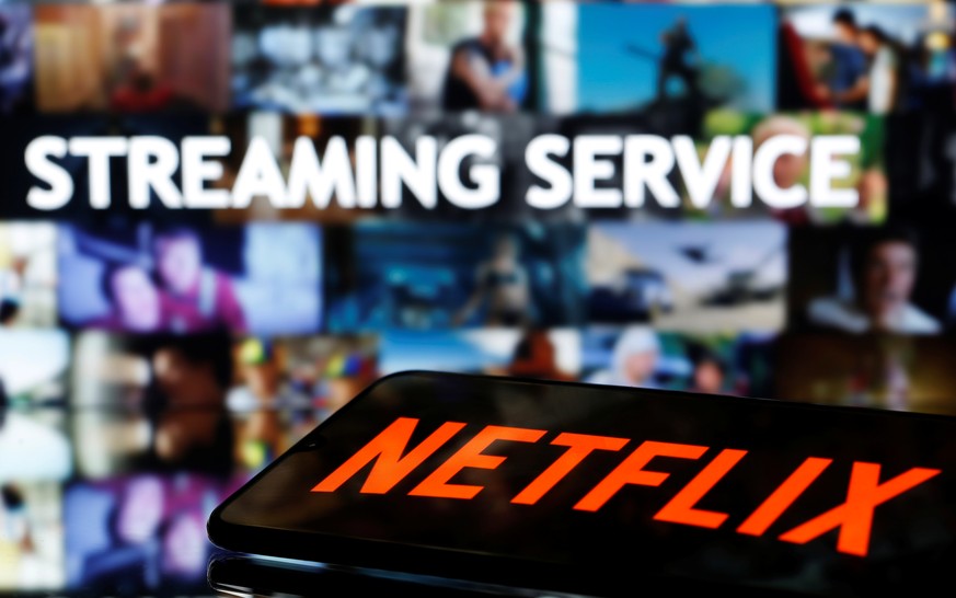 A smartphone with the Netflix logo lies in front of displayed &quot;Streaming service&quot; words in this illustration taken March 24, 2020. REUTERS/Dado Ruvic