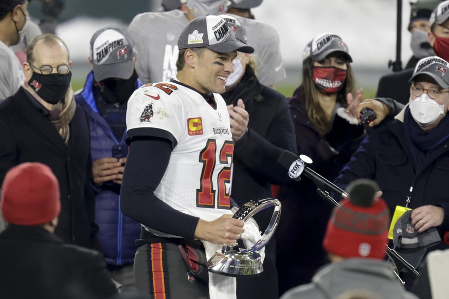 Tampa Bay Buccaneers quarterback Tom Brady (12) holds the championship trophy after winning the NFC championship NFL football game against the Green Bay Packers in Green Bay, Wis., Sunday, Jan. 24, 20 ...