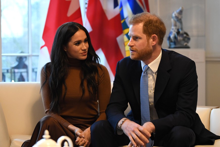 LONDON, UNITED KINGDOM - JANUARY 07: Prince Harry, Duke of Sussex and Meghan, Duchess of Sussex gesture during their visit to Canada House in thanks for the warm Canadian hospitality and support they  ...