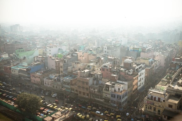 Top view of the city street in the poor quarter of new Delhi. Air pollution and smog in crowded cities.