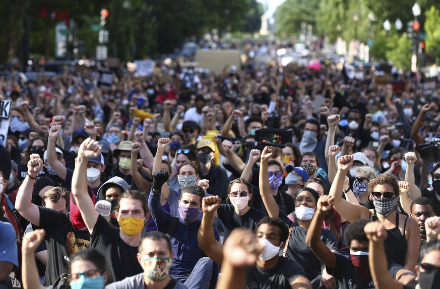Marchers protesting the Minnesota police killing of George Floyd hold a demonstration near the White House on Tuesday, June 2, 2020 in Washington D.C. Activists nationwide defied curfews in some of th ...