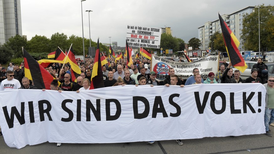 People carry a banner reading &quot;we are the people&quot; during a demonstration in Chemnitz, eastern Germany, Friday, Sept.7, 2018, after several nationalist groups called for marches protesting th ...