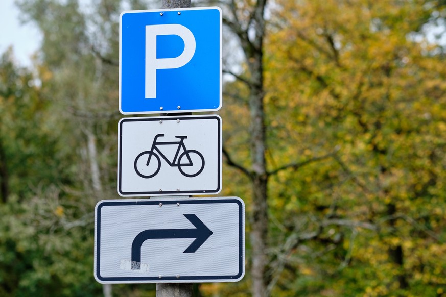 Traffic signs informing about a parking space for bicycles on the right side in October in Germany