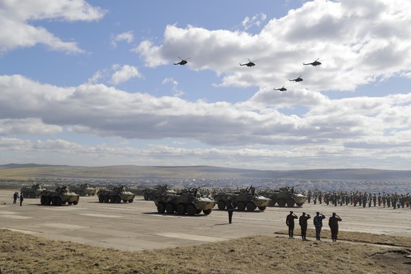 Military vehicles and helicopters in motion during a parade on training ground &quot;Telemba&quot;, about 80 kilometers (50 miles ) north of the city of Chita during the military exercises Vostok 2018 ...