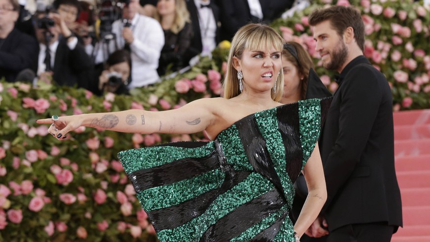 Miley Cyrus and Liam Hemsworth arrive on the red carpet at The Metropolitan Museum of Art s Costume Institute Benefit Camp: Notes on Fashion at Metropolitan Museum of Art in New York City on May 6, 20 ...