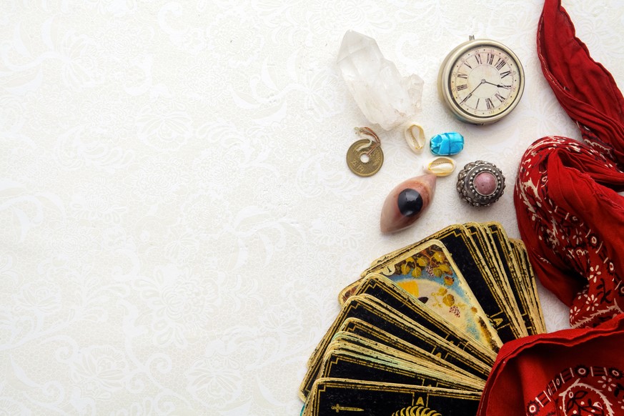 Composition of esoteric objects, used for healing and fortune-telling on light background