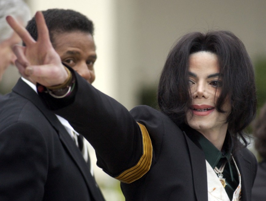 FILE - In this March 2, 2005, file photo, pop icon Michael Jackson waves to his supporters as he arrives for his child molestation trial at the Santa Barbara County Superior Court in Santa Maria, Cali ...