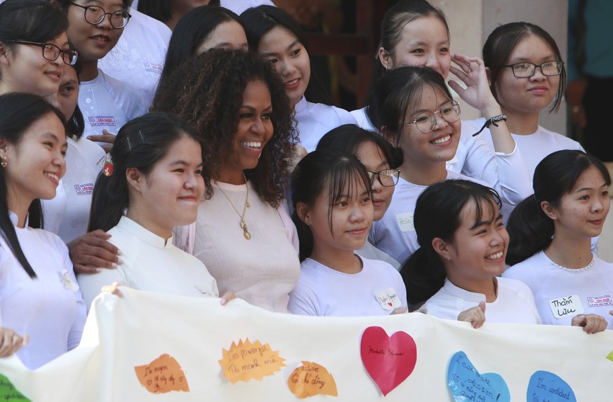 Former U.S. first lady Michelle Obama stands for a photo with female students at the Can Giuoc high school in Long An province, Vietnam, Monday, Dec. 9, 2019. Mrs. Obama is on a visit to Vietnam to pr ...
