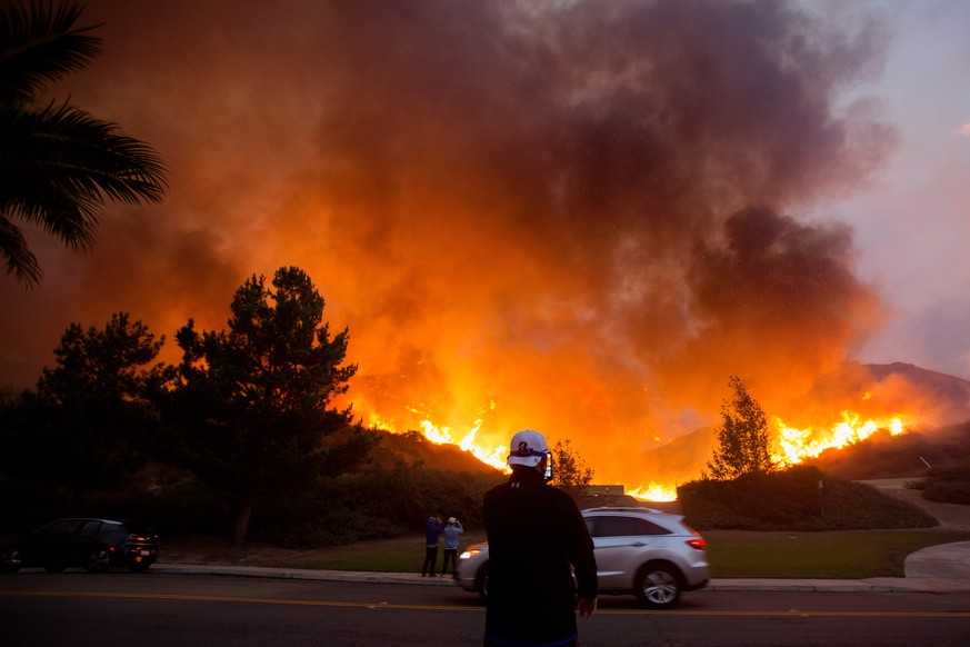 Residents take photos of the Blue Ridge Fire burning in Yorba Linda, California, U.S., October 26, 2020. REUTERS/Ringo Chiu