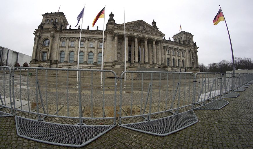 Crowd control barriers are placed in front of the Reichstag building, home of the German federal parliament (Bundestag), in Berlin, Germany, Tuesday, Jan. 12, 2021. (AP Photo/Michael Sohn)