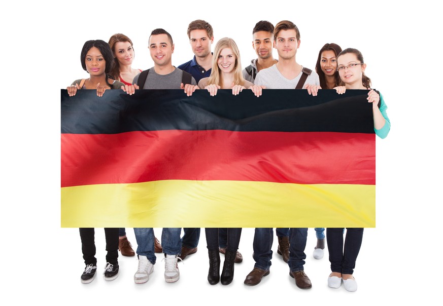 Group Of Young People Holding German Flag Against White Background