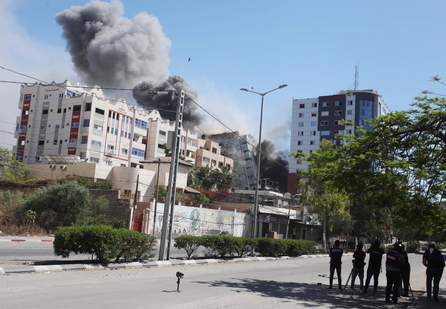 May 15, 2021, Gaza city, Gaza Strip, Palestinian Territory: Smoke rises after an Israeli airstrike hits Al-Jalaa tower, which houses apartments and several media outlets, including The Associated Pres ...