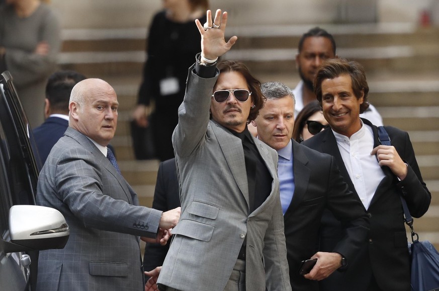 American actor Johnny Depp, waves as he leaves after the end of the trial at the High Court in London, Tuesday, July 28, 2020. Hollywood actor Johnny Depp is suing News Group Newspapers over a story a ...