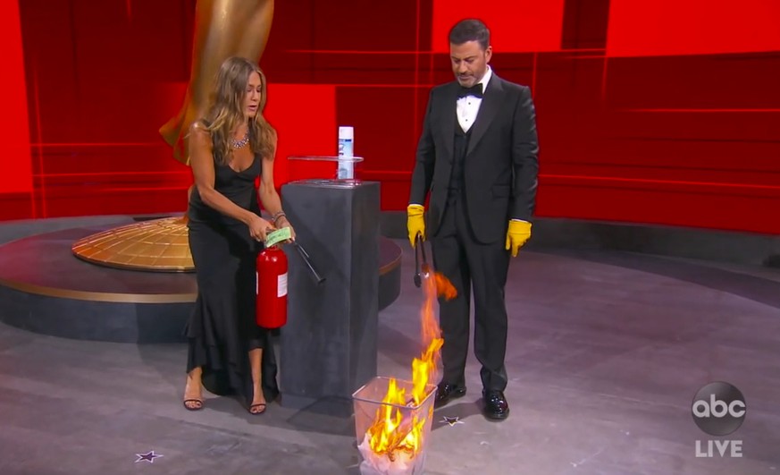 In this video grab captured on Sept. 20, 2020, courtesy of the Academy of Television Arts &amp; Sciences and ABC Entertainment, Jennifer Aniston, left, and Jimmy Kimmel sanitize the winner&#039;s enve ...