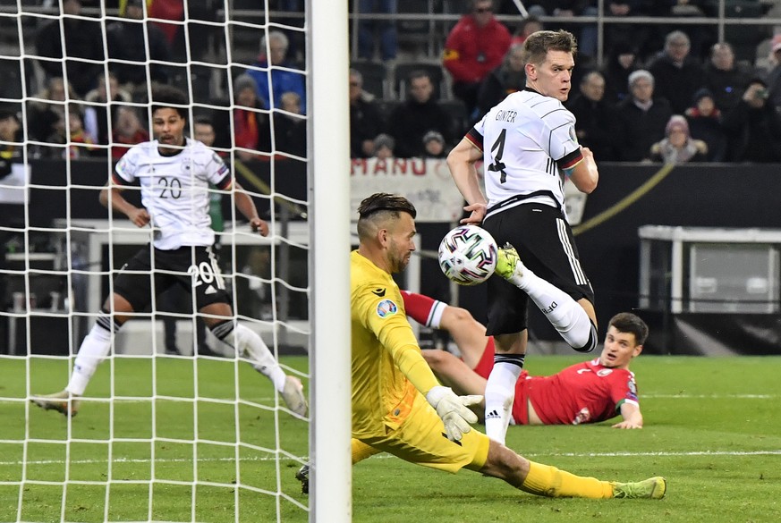 Germany&#039;s Matthias Ginter, center, scores the opening goal against Belarus&#039; keeper Aleksandr Gutor during the Euro 2020 group C qualifying soccer match between Germany and Belarus in Moenche ...