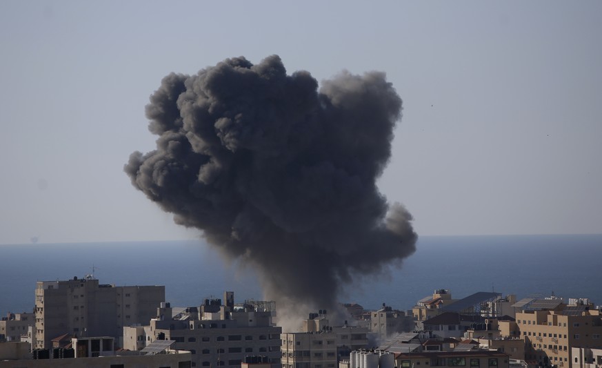 Smoke rises following Israeli airstrikes on a building in Gaza City, Friday, May 14, 2021. (AP Photo/Hatem Moussa)