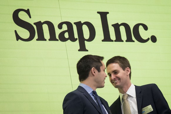 NEW YORK, NY - MARCH 2: (L to ) Snapchat co-founders Bobby Murphy, chief technology officer of Snap Inc., and Evan Spiegel, chief executive officer of Snap Inc., smile at each other after ringing the  ...