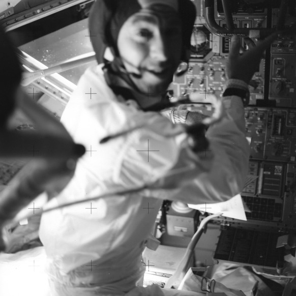 In this April 17, 1970 photo made available by NASA, astronaut Jim Lovell, inside the Apollo 13 lunar module, prepares it for jettison before returning to the command module for splashdown in the Paci ...