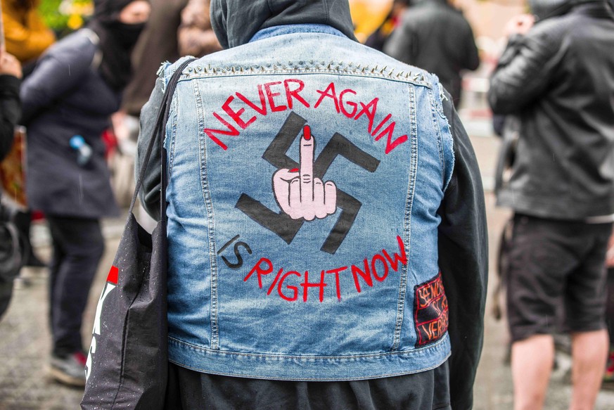 May 1, 2020, Munich, Bavaria, Germany: Never again or nie wieder with a swastika used to demonstrate against the III. Weg neonazi group in Munich, Germany. Despite the ongoing Coronavirus crisis, 14 f ...