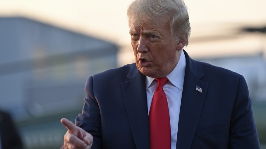 President Donald Trump talks with reporters before departing from Morristown Municipal Airport in Morristown, N.J., Sunday, Aug. 9, 2020. Trump was returning to Washington after spending the weekend a ...