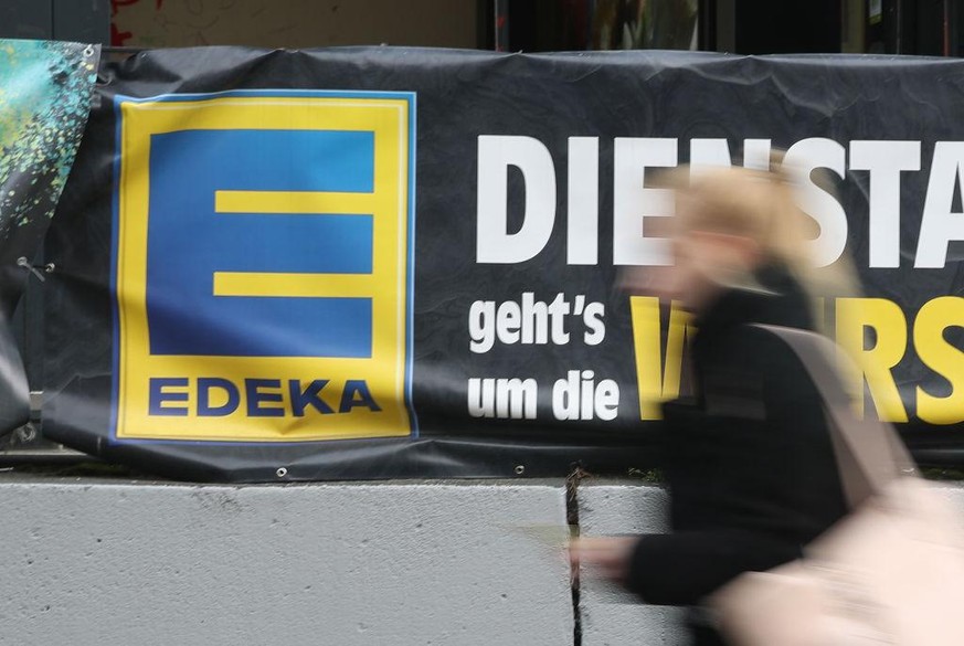 BERLIN, GERMANY - FEBRUARY 19: A young woman walks past a grocery store of German chain Edeka on February 19, 2018 in Berlin, Germany. According to media reports Agecore-Group, to which Edeka belongs, ...