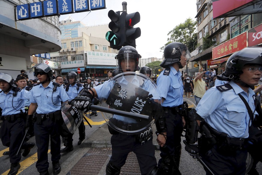 Hong Kong police push back protesters in Hong Kong Saturday, July 13, 2019. Several thousand people marched in Hong Kong on Saturday against traders from mainland China in what is fast becoming a summ ...