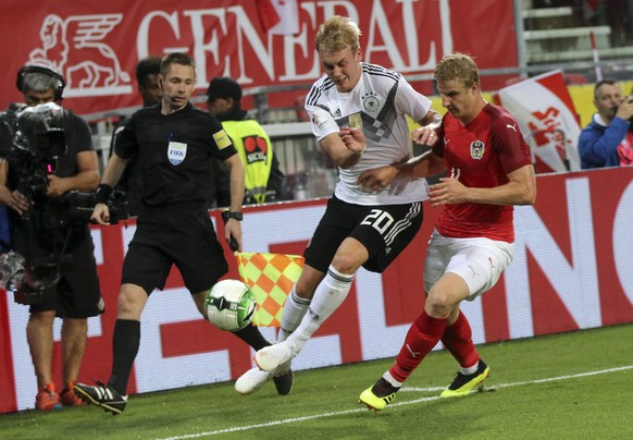 Germany&#039;s Julian Brandt fights for the ball with Austria&#039;s Thomas Murg, right, during a friendly soccer match between Austria and Germany in Klagenfurt, Austria, Saturday, June 2, 2018. (AP  ...