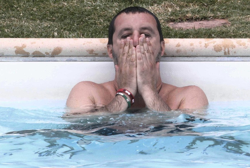 Interior Minister Matteo Salvini bathes in the swimming pool as he visits a farm confiscated in 2007 from a mobster to emphasize anti-Mafia procedures, in Suvignano, near Siena, central Italy, Tuesday ...