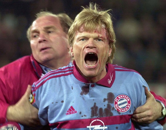FILE PHOTO: ON THIS DAY -- April 12 April 12, 2000 SOCCER - Bayern Munich general manager Uli Hoeness tries to calm down keeper Oliver Kahn, who was struck in the head by a golf ball thrown by the cro ...