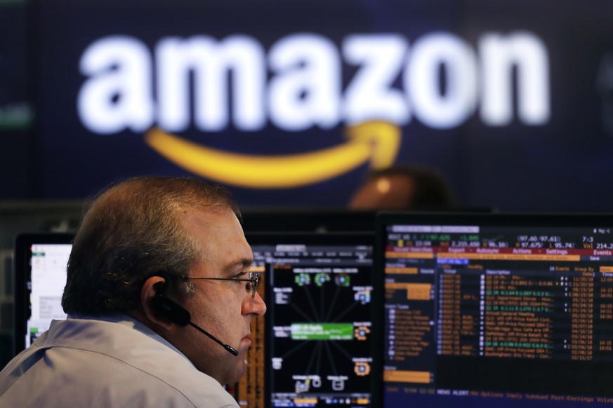 A Nasdaq employee monitors market activity Tuesday, Sept. 4, 2018, in New York. Amazon became the second publicly traded company to be worth $1 trillion, hot on the heels of Apple. (AP Photo/Mark Lenn ...