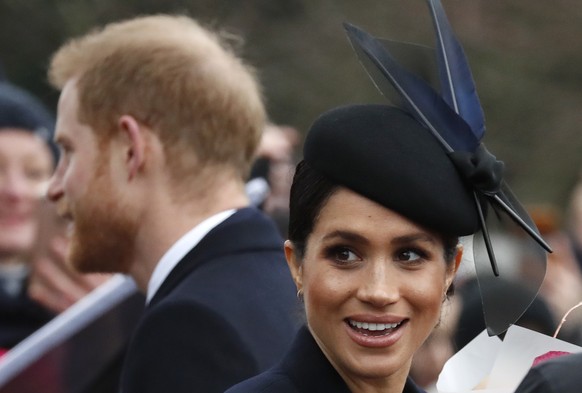 Britain&#039;s Prince Harry and Meghan, Duchess of Sussex meet members of the crowd after attending the Christmas day service at St Mary Magdalene Church in Sandringham in Norfolk, England, Tuesday, D ...
