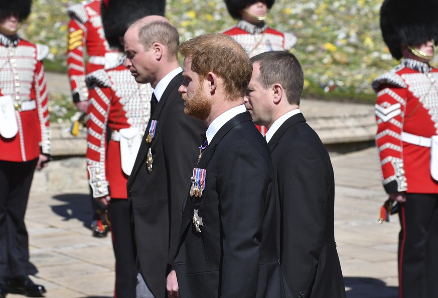 Prince William, left, Prince Harry and Peter Phillips, right, follow the coffin during a procession arriving at St George&#039;s Chapel for the funeral of Britain&#039;s Prince Philip inside Windsor C ...