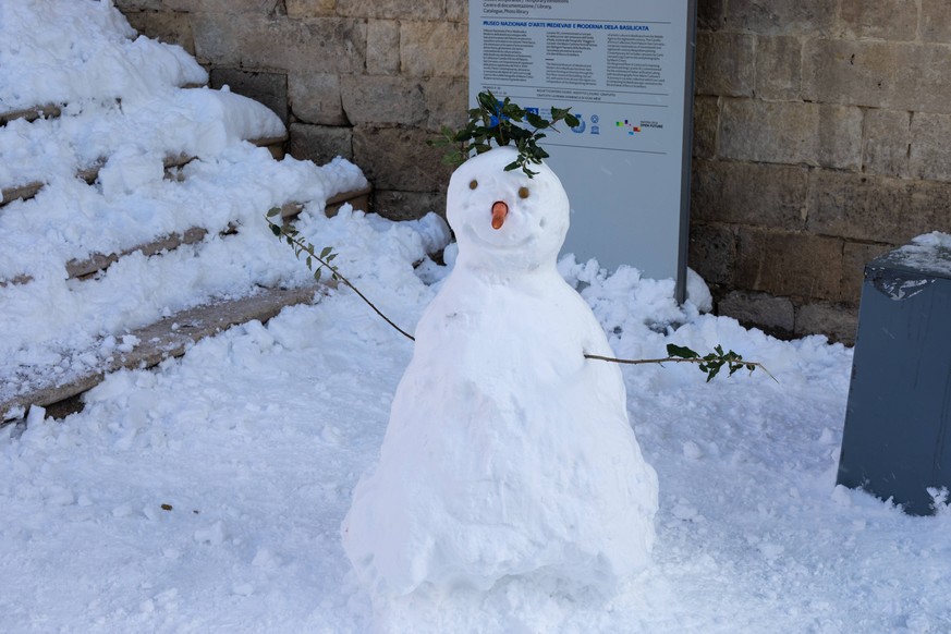 January 4, 2019 - Matera, MT, Italy - A snowman seen in the Sassi di Matera after a long snowfall when the sun shines on the snow-covered rocks of matera, making a beautiful postcard of the European c ...
