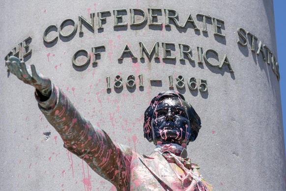 Paint and protest graffiti covers the Jefferson Davis Memorial in Richmond, Va., Sunday, June 7, 2020, following a week of unrest in the U.S. against police brutality and racism in policing. Jefferson ...