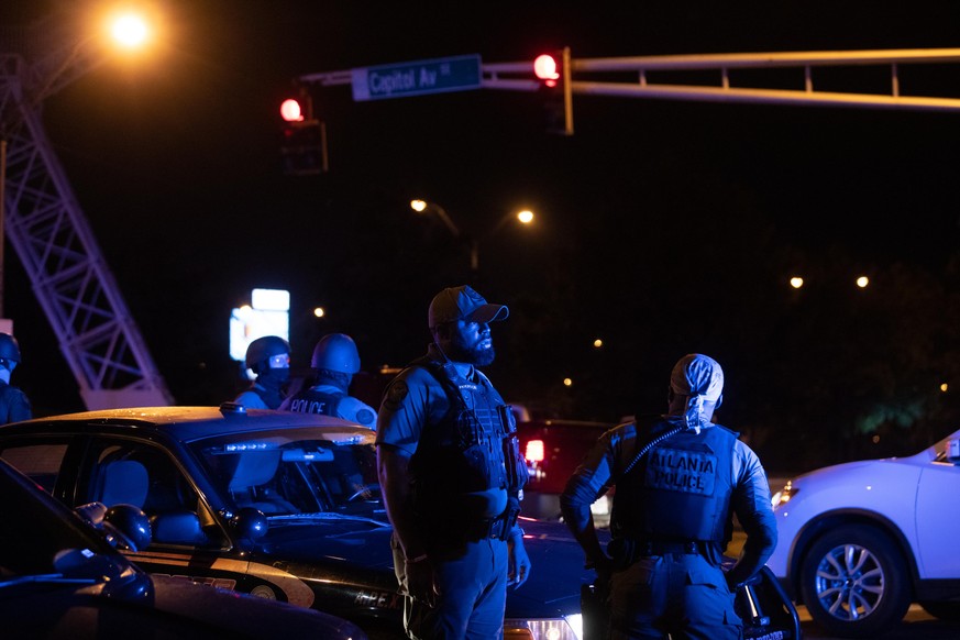 ATLANTA, GA - JUNE 14: Police watch the streets after a day of marches on June 14, 2020 in Atlanta, Georgia. A memorial is found at the ste of the Wendy&#039;s restaurant which was set ablaze overnigh ...