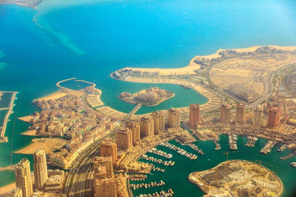Aerial view of the Pearl-Qatar, the luxurious modern artificial island in the Persian Gulf, Venice at Qanat Quartier, Marsa Malaz Kempinski hotel and towers of Porto Arabia, Doha, Qatar, Middle East.  ...