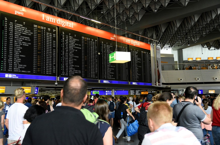 People wait at the Frankfurt Airport due to the evacuation in Frankfurt, Germany August 7, 2018. REUTERS/Florian Ulrich NO RESALES. NO ARCHIVES.