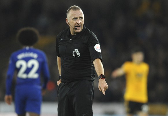 Referee Jonathan Moss gestures during the English Premier League soccer match between Wolverhampton Wanderers and Chelsea at the Molineux Stadium in Wolverhampton, England, Wednesday, Dec. 5, 2018. (A ...