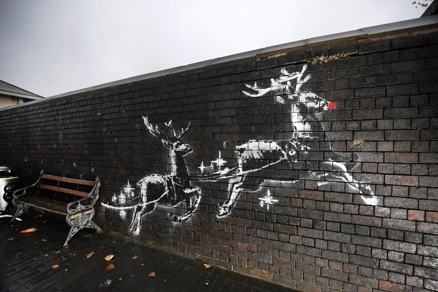 BIRMINGHAM, ENGLAND - DECEMBER 10: Red noses have appeared on Banksy&#039;s Birmingham homeless reindeer mural , which has also been fenced off to protect the artwork, on a railway bridge wall in Vyse ...