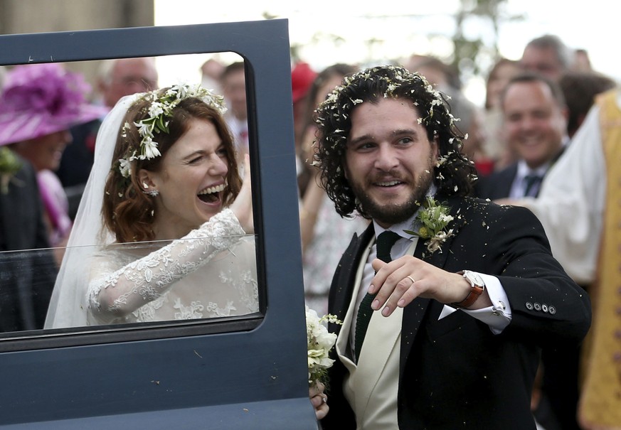 Actors Kit Harington and Rose Leslie react as they leave after their wedding ceremony, at Rayne Church, Kirkton of Rayne in Aberdeenshire, Scotland, Saturday June 23, 2018. Former &quot;Game of Throne ...