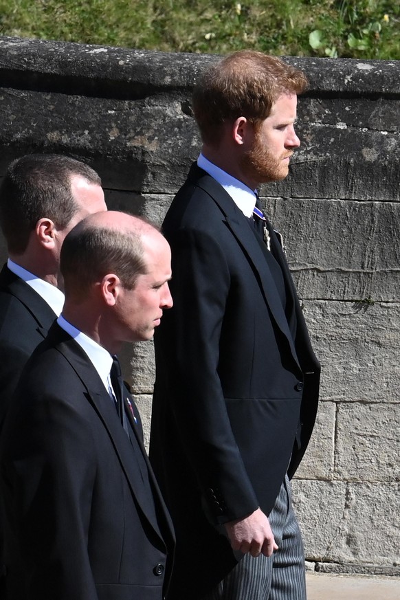 WINDSOR, ENGLAND - APRIL 17: Prince William, Duke of Cambridge, Peter Phillips and Prince Harry, Duke of Sussex follow Prince Philip, Duke of Edinburgh&#039;s coffin during the Ceremonial Procession d ...