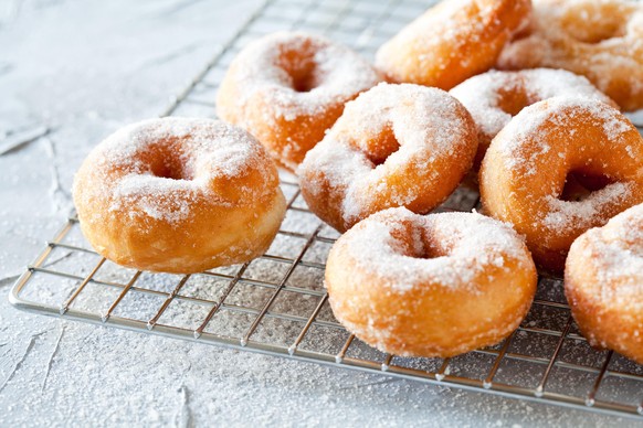 Bunch of homemade donuts with powdered sugar