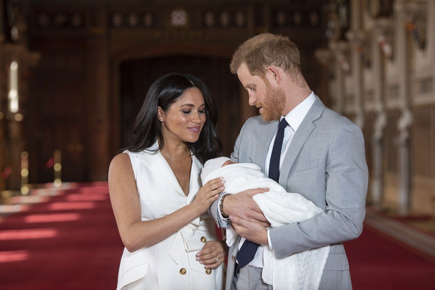 FILE - In this Wednesday May 8, 2019 file photo, Britain&#039;s Prince Harry and Meghan, Duchess of Sussex, pose during a photocall with their newborn son Archie, in St George&#039;s Hall at Windsor C ...
