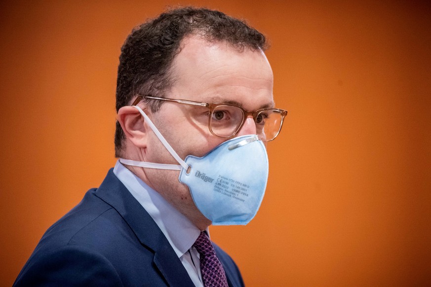 FILE PHOTO: German Health Minister Jens Spahn wears a protective mask before the weekly cabinet meeting of the German government at the chancellery in Berlin, Germany, November 25, 2020. Michael Kappe ...